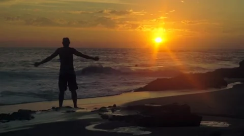 Man doing yoga on the beach at sunset Stock-Footage 46086179
