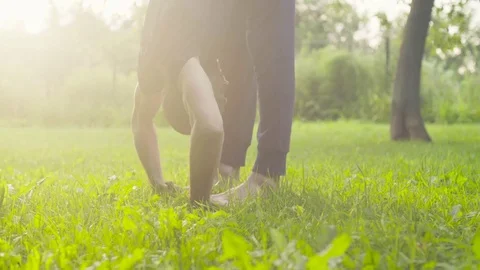 A man doing yoga exercises in the park Stock Footage