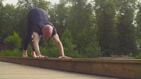 A man doing yoga exercises in the park Stock Footage 79402722
