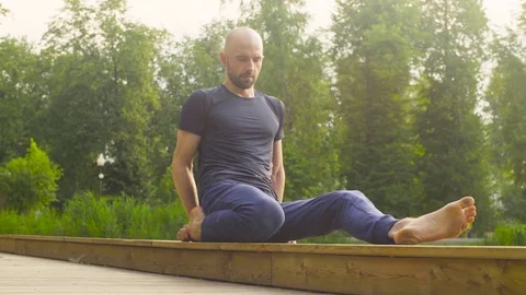 A man doing yoga exercises in the park 스톡 동영상 79405919