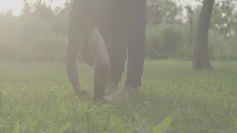 A man doing yoga exercises in the park Stock Footage