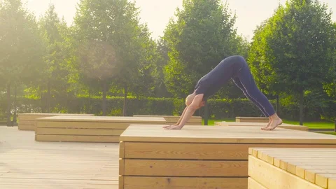 A man doing yoga exercises in the park Stock Footage