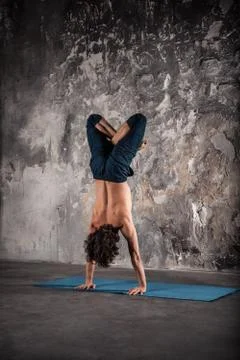 Man doing yoga exercises. Stock Photos