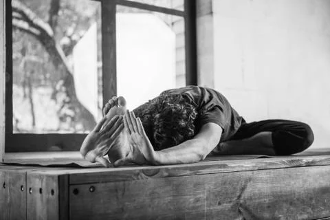 Man doing yoga exercises. Stock Photos