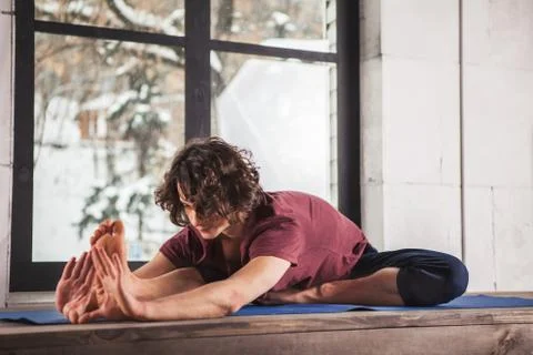 Man doing yoga exercises. Stock Photos