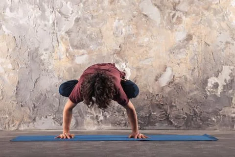 Man doing yoga exercises. Practicing yoga Stock Photos