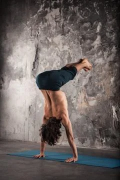 Man doing yoga exercises. Practicing yoga Stock Photos