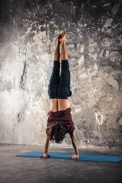 Man doing yoga exercises. Practicing yoga Stock Photos