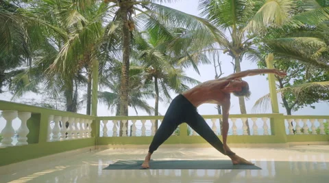 Man doing yoga outdoors Stock Footage 61749308