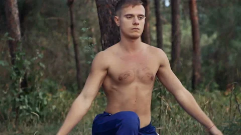 Man doing yoga in the woods Stock Footage 96379664