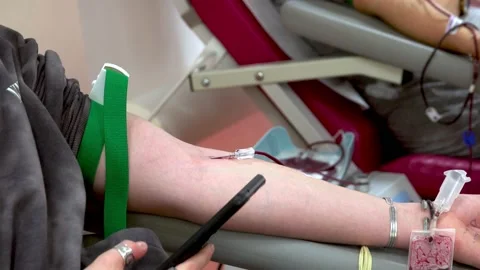 Man donating blood. Focus on hand. Stock Footage 228853376