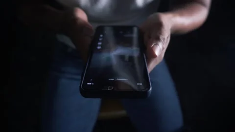 Man doomscrolling on a smartphone at night Video stock 344756930