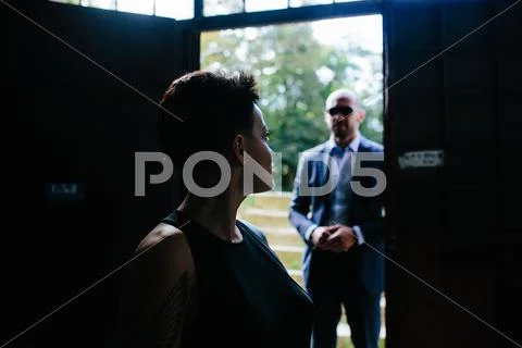 Man in the doorway, silhouette of a woman Stock Photos