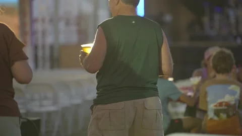 Man double fisting beers at event Stock Footage 288901424