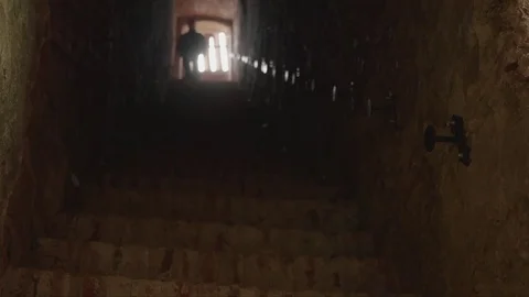 Man down stairs brick in a tunnel of an old fortress Video stock 82312901