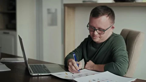 Man with down syndrome learning at home using laptop Video stock 228853966