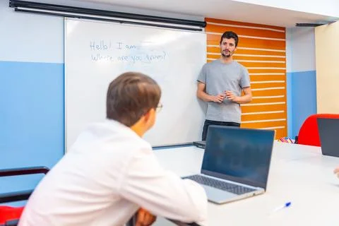 Man with down syndrome using laptop during IT class Stock Photos