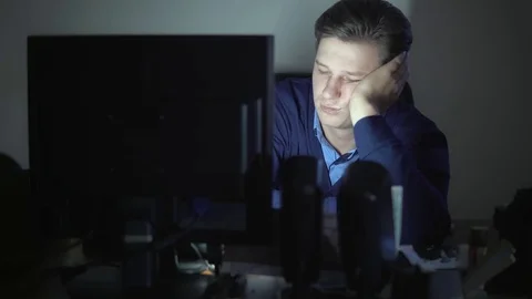 The man is dozing at night in the office at the computer Stock Footage 82542341