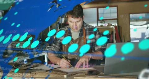 Man drafting and measuring on woodshop bench as laptop sending data overlaying 스톡 동영상 331085441