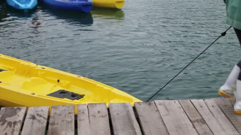 Man dragging kayak on water. Stock Footage 303367849