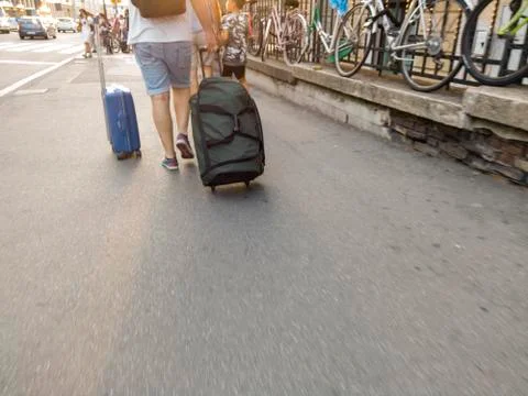 Man dragging roller suitcase Photos