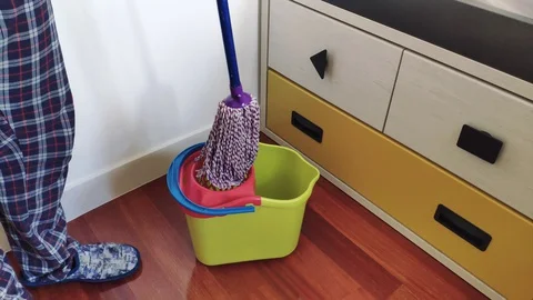 Man draining the mop and cleaning up at home. Stock Footage 128112731