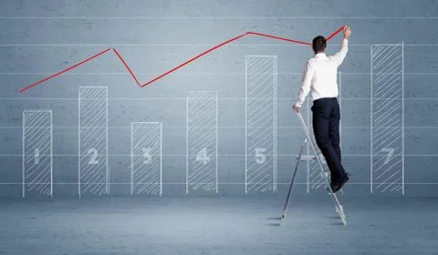 Man drawing chart from ladder 库存照片