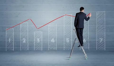Man drawing chart from ladder 库存照片