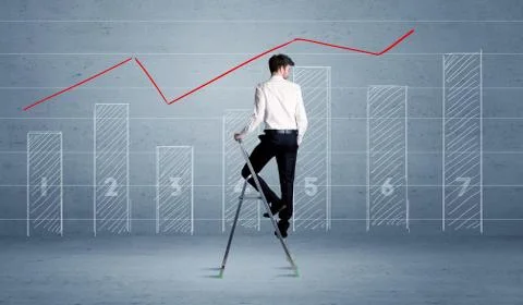 Man drawing chart from ladder 库存照片
