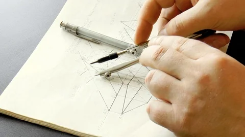 Man drawing a drawing with a compass Stock Footage 79539075