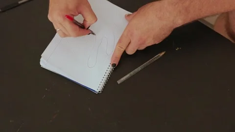 Man drawing hand contour on notepad Stock Footage 316127996