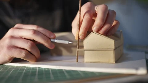 A man is drawing a house with a ruler Video stock 302442657