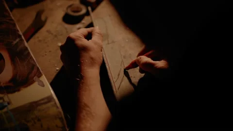 Man drawing knife shape with blade and handle on metal plate in workshop Vidéo 167172658