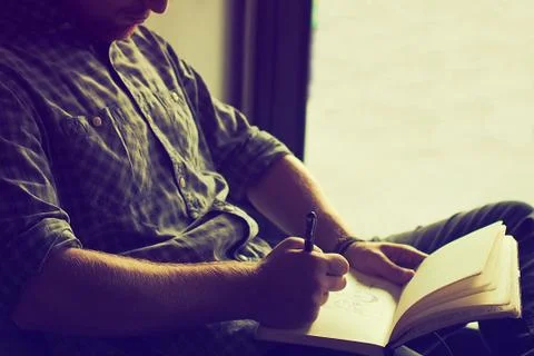 Man drawing on the notebook Stock Photos