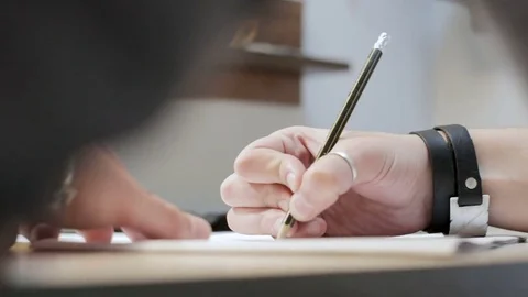 Man drawing with a simple pencil on a paper on the table Stock Footage 80098921