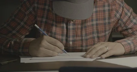 Man Drawing On White Paper Sitting at Desk Stock-Footage 101405391
