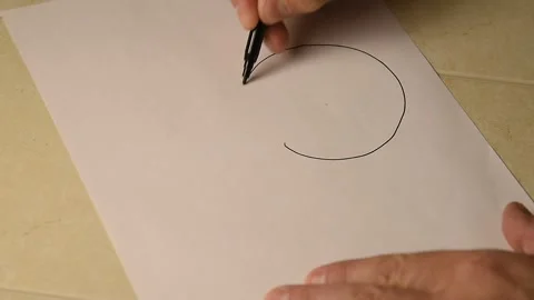 A man draws bitcoin on paper with a black felt-tip pen. Stock Footage 145087478