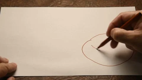 A man draws bitcoin on paper. Stock Footage 145091243