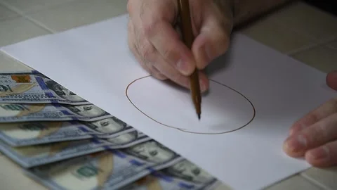 A man draws bitcoin, virtual money. Stock Footage 145142953