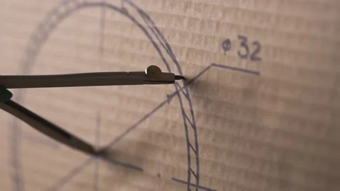 Man draws a circle with a compass on cardboard. Stock Footage 143546446