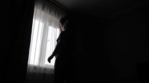 The man draws the dark curtains and does not allow light into the room. Stock Footage 263236546