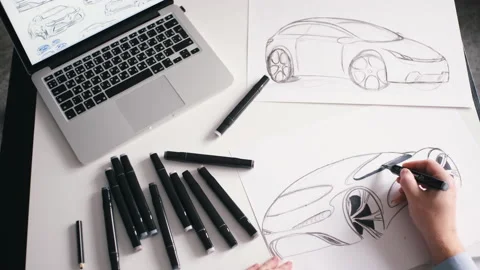 A man draws a design project for a future car at home studio Stock Footage 142606726