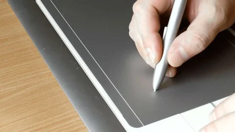 Man draws on a graphic tablet for drawing Stock Footage 79276888