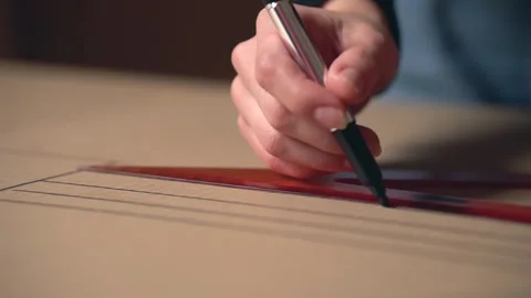 Man draws a line on a ruler with a marker. Close-up. Stock Footage 143707254