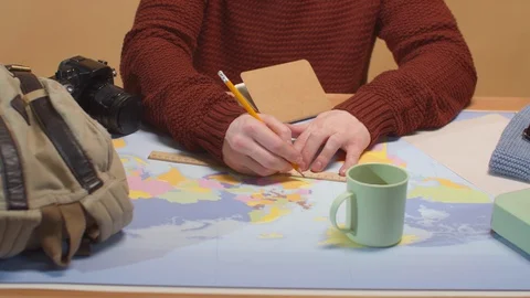 A man draws on a map on a ruler. Close up Stock Footage 129979703