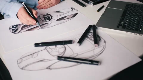 A man draws a new design project for a future car at home Stock Footage 142606839
