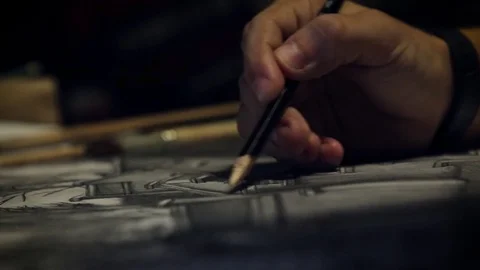 A man draws with a pencil Stockbeeldmateriaal 82742189