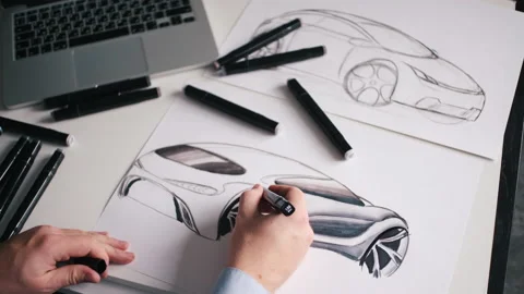 A man draws a project for a future car at home Stock Footage 142606613