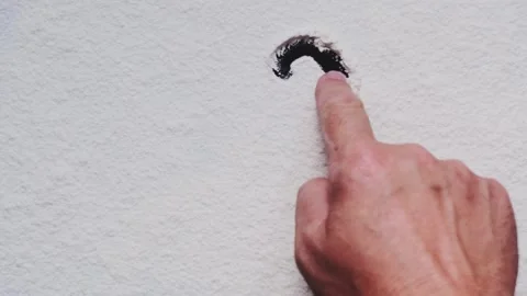 A man draws a question mark with his finger on a white background. Stock Footage 248781266