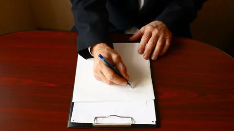 The man draws the schedule on a clean sheet. Video stock 86988880